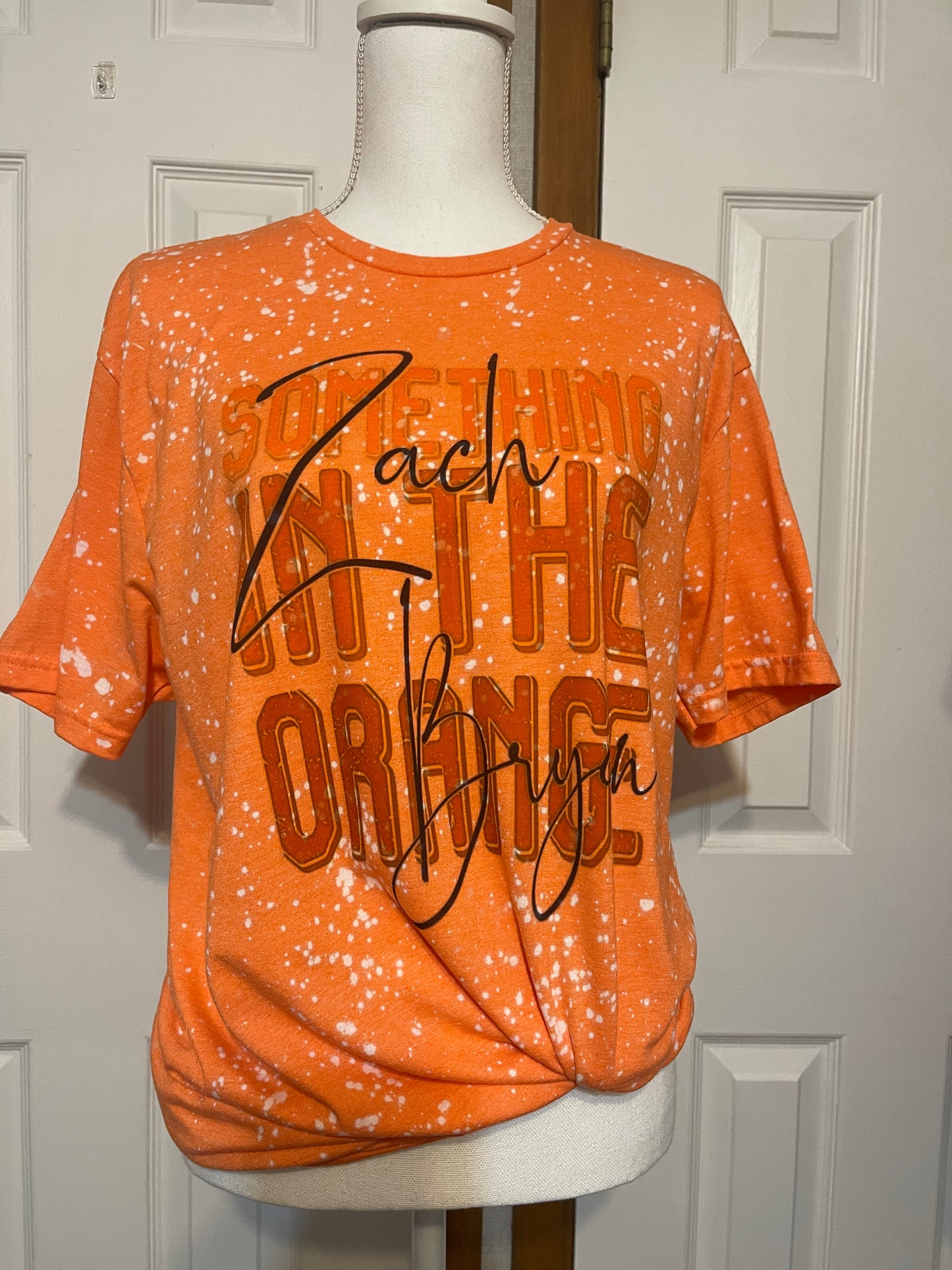 Something in the orange tee